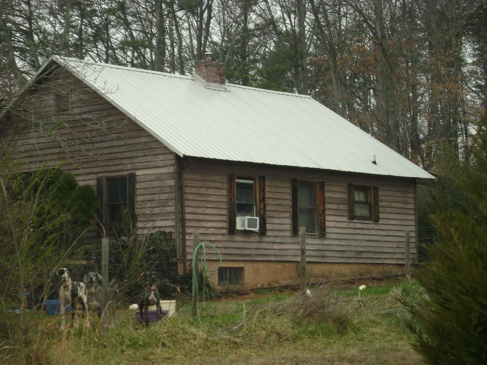 White metal roof on an old wood sided farmhouse, from a Metal Roof Installation job in Bladensburg